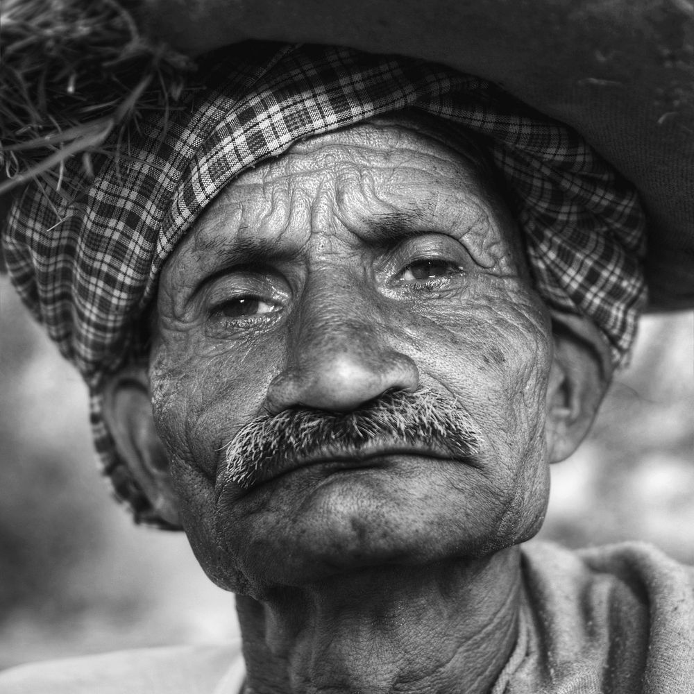 Indigenous senior Indian man looking grumpy at the camera.