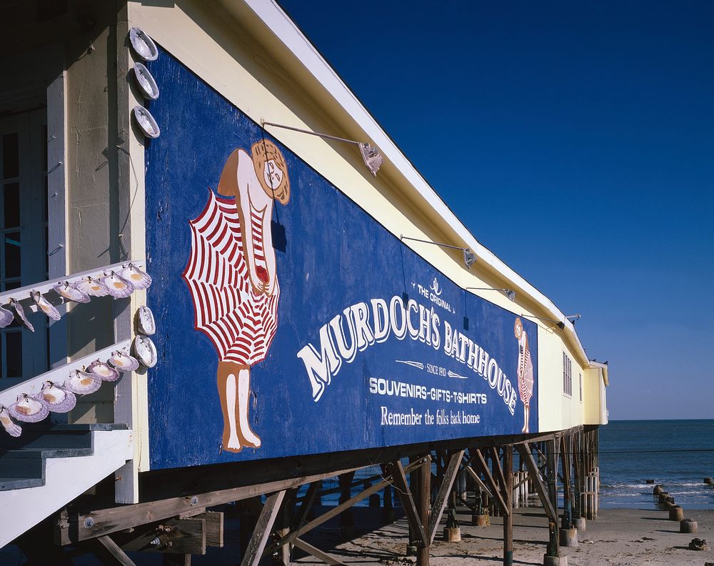 Sign for Murdoch's Bathhouse, with a peek at the Gulf of Mexico in Galveston. Original image from Carol M. Highsmith&rsquo;s…