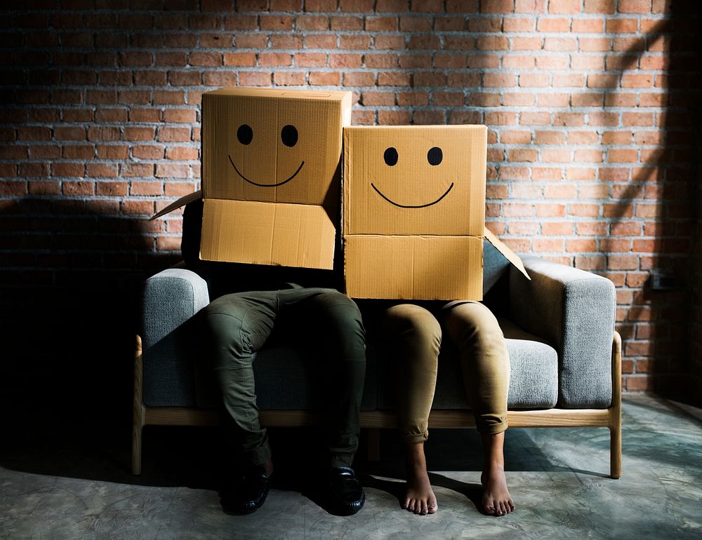 Couple wearing boxes with smiley faces