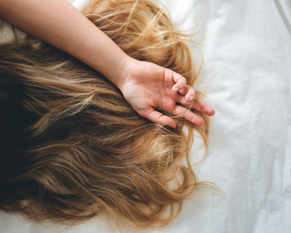 Woman with Brunette Hair Lying Down on the Bed