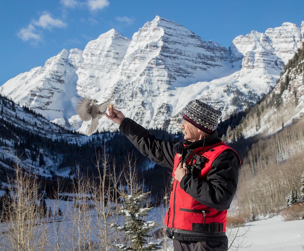 When T-Lazy-7 Ranch snowmobile driver Charles Chisholm arrives at a favorite scenic spot near the Maroon Bells mountain…