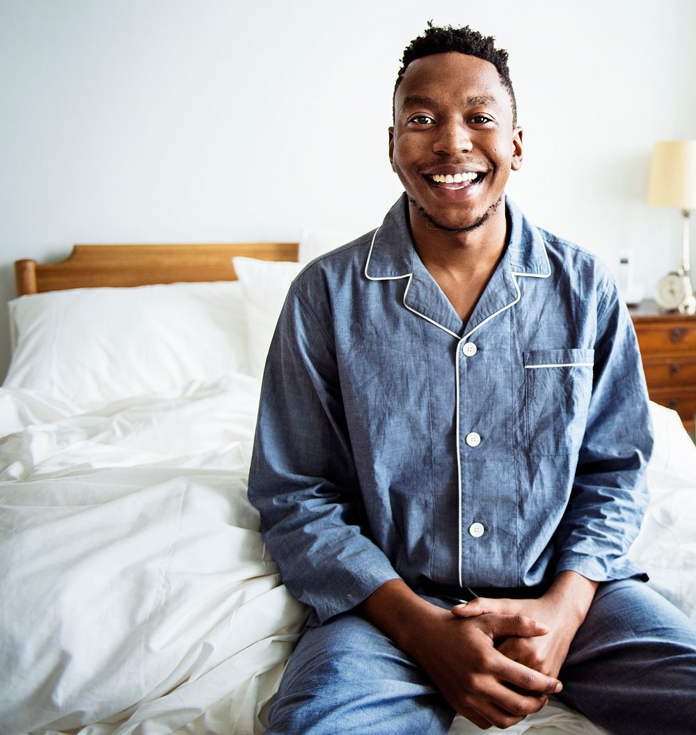 A smiling man in bed