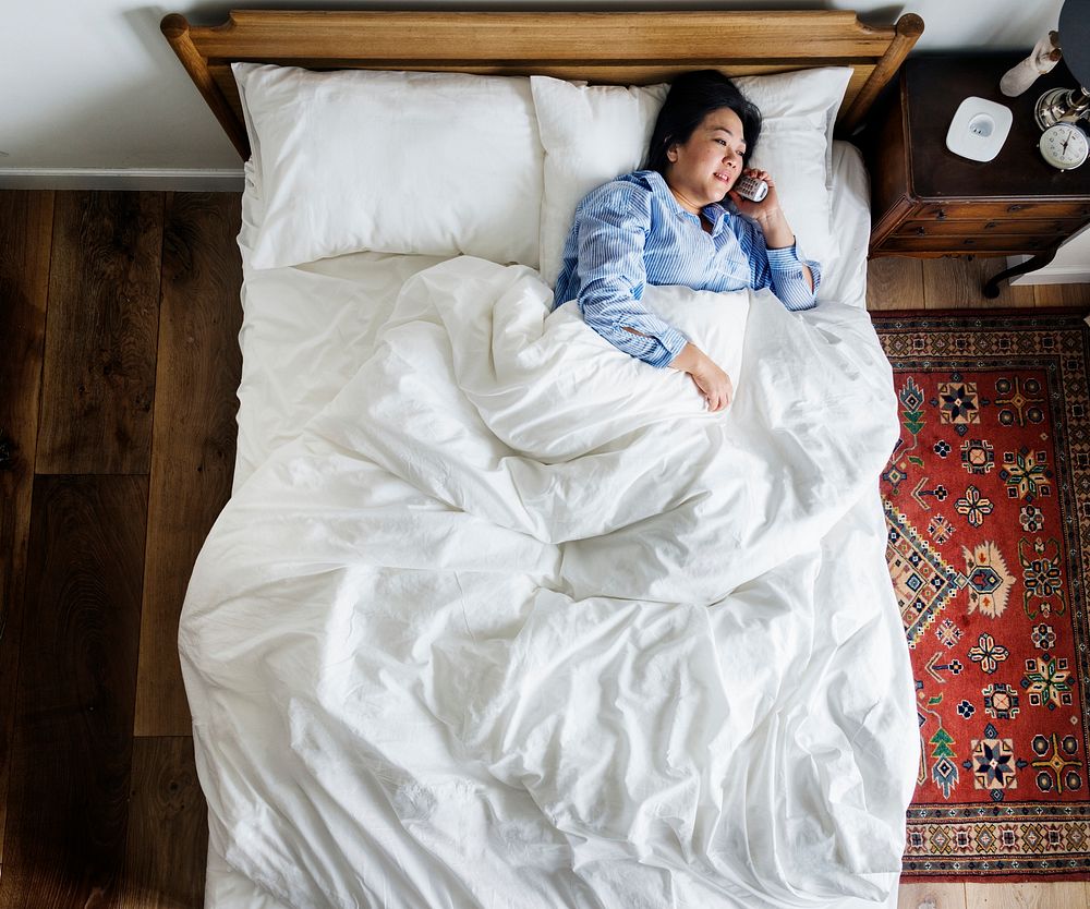 Woman in bed talking on the phone