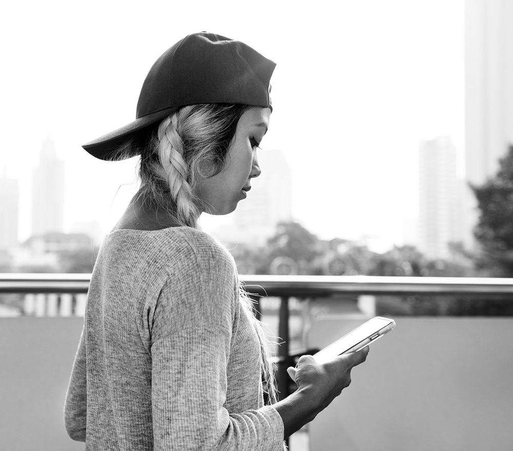 Young woman using a smartphone in the cityscape