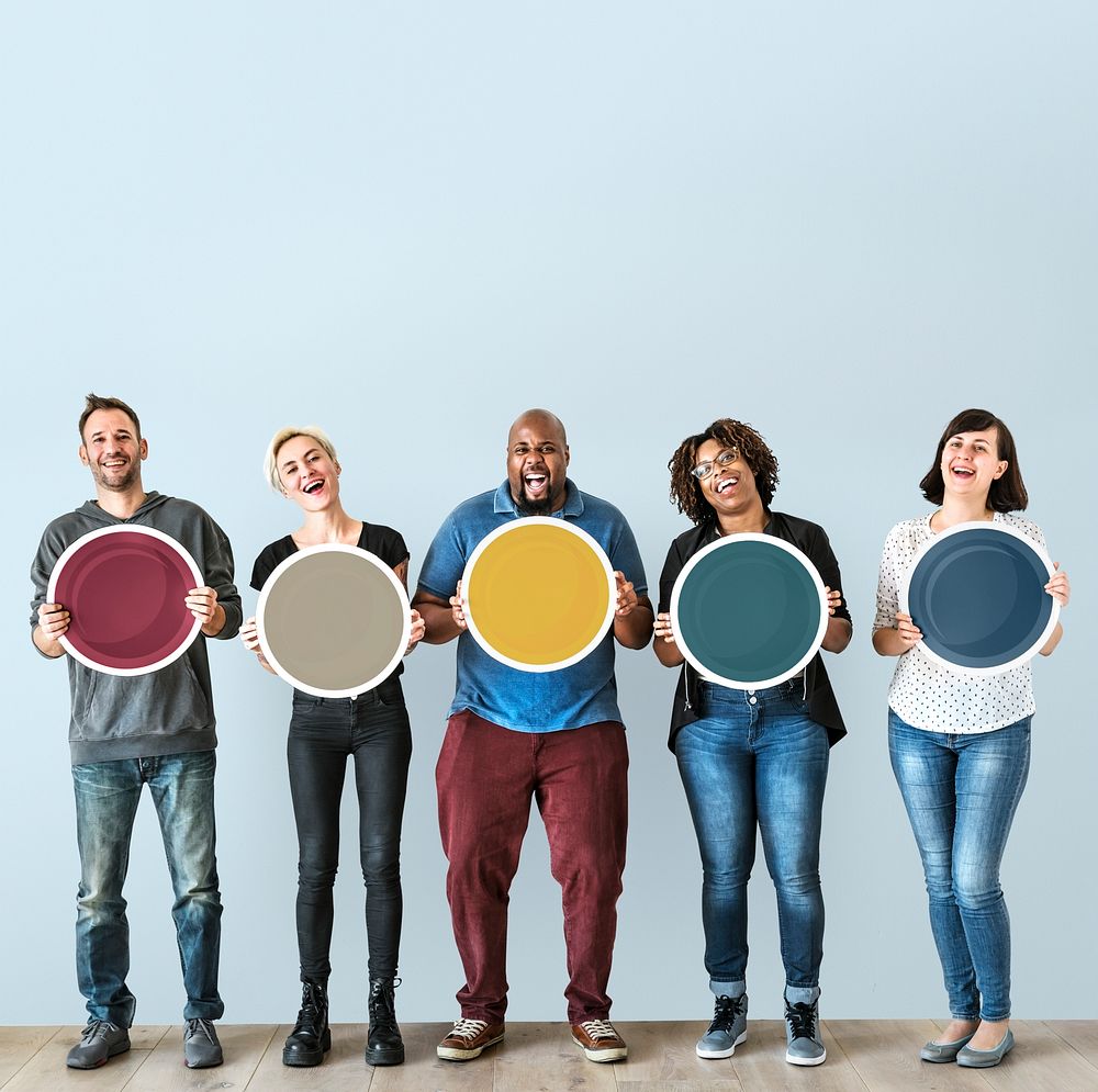 Diverse people holding blank round board