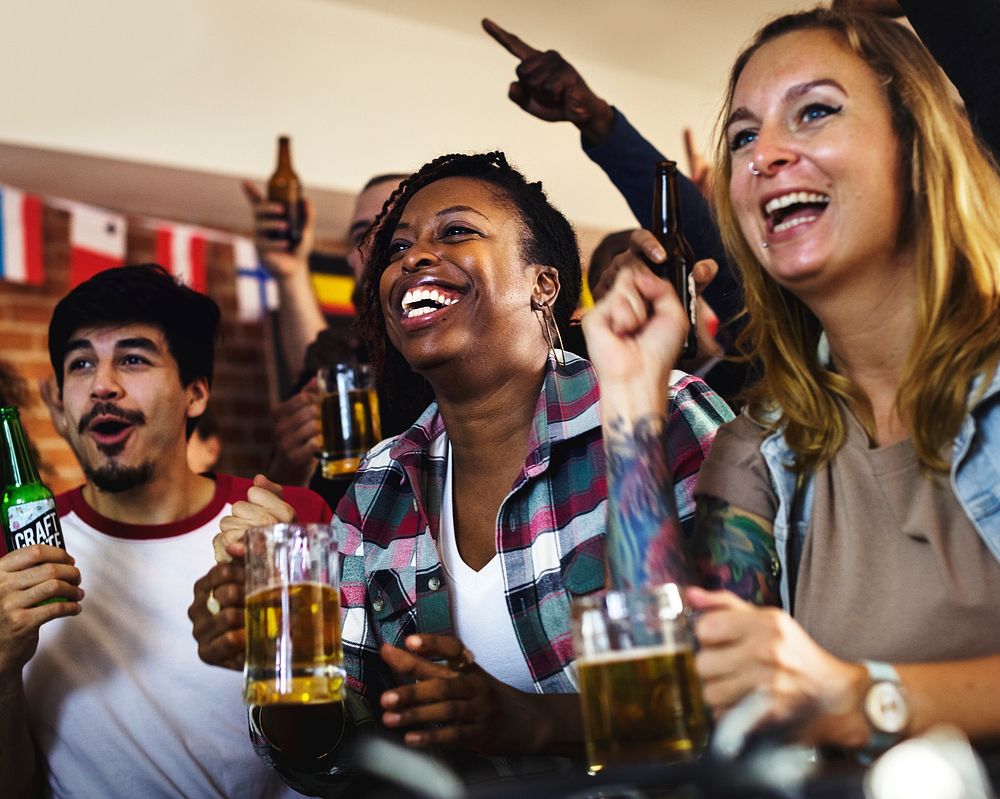 Friends cheering sport at bar together