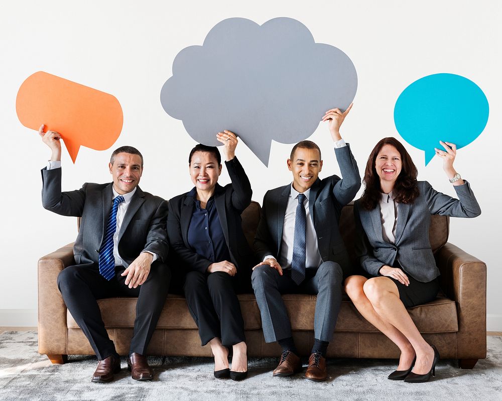 Cheerful business people holding speech bubble