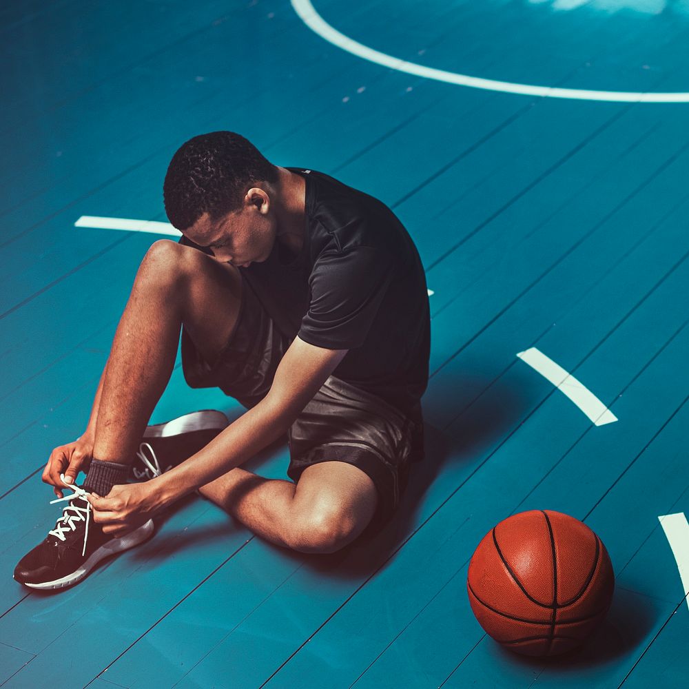 Basketball player tying his shoelaces