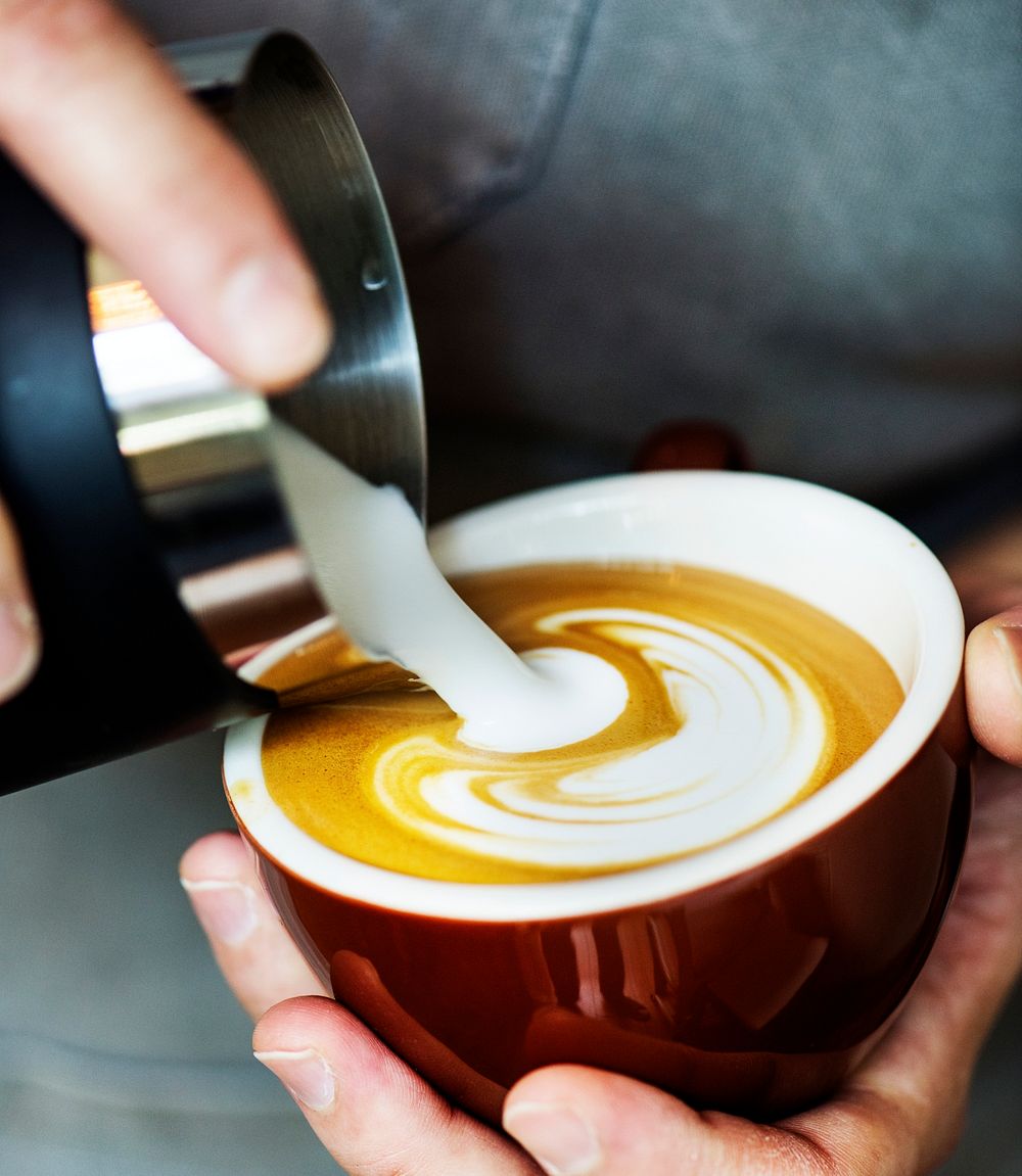 Closeup of barista making latte art