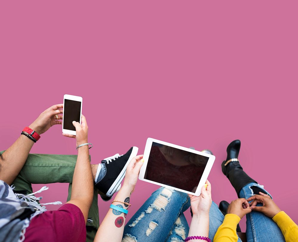 Colorful teens using digital devices with an empty screen