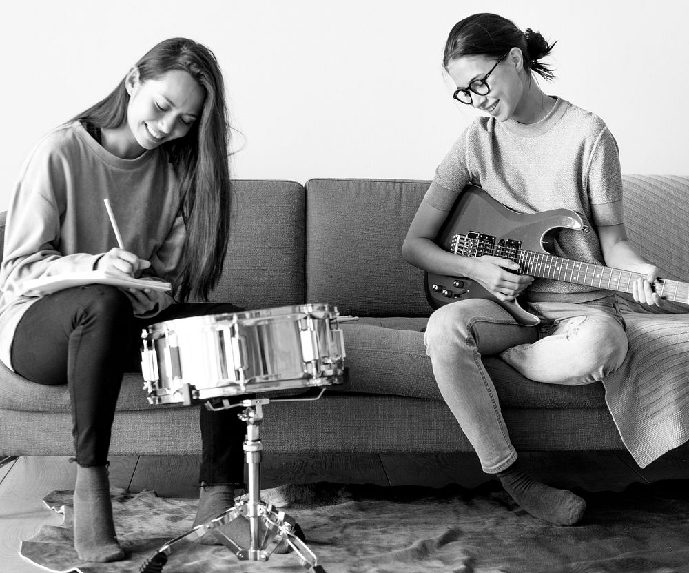 Women playing music together at home