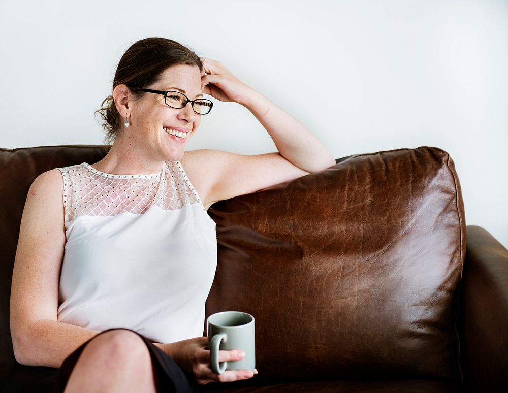 Woman sitting on a couch holding a mug