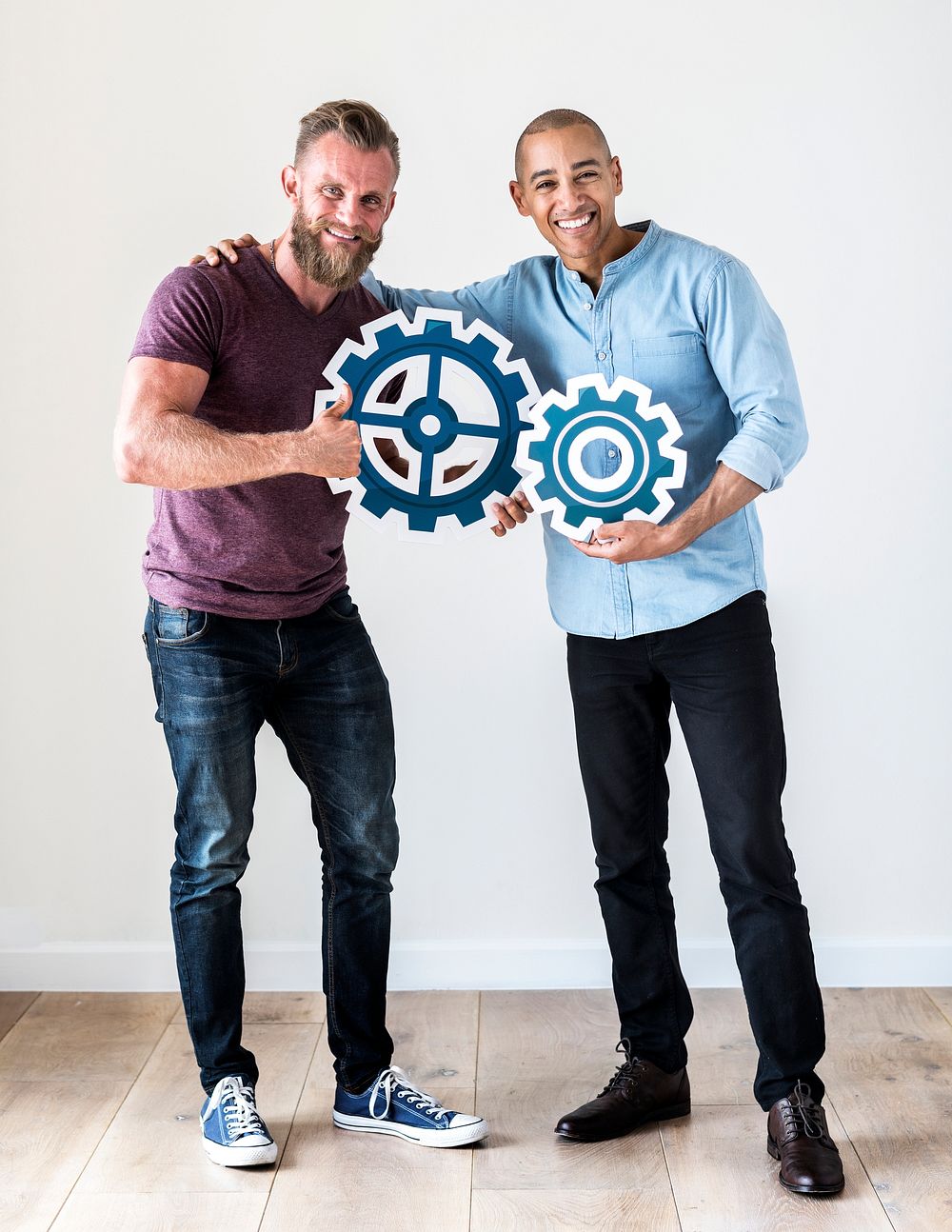 Two casual man holding cog icon