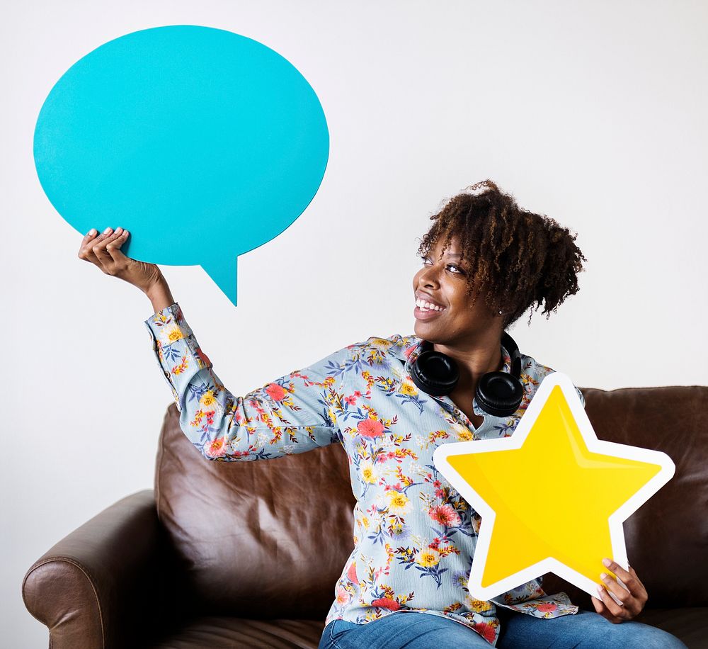Happy African American holding copy space speech bubble and a star sign