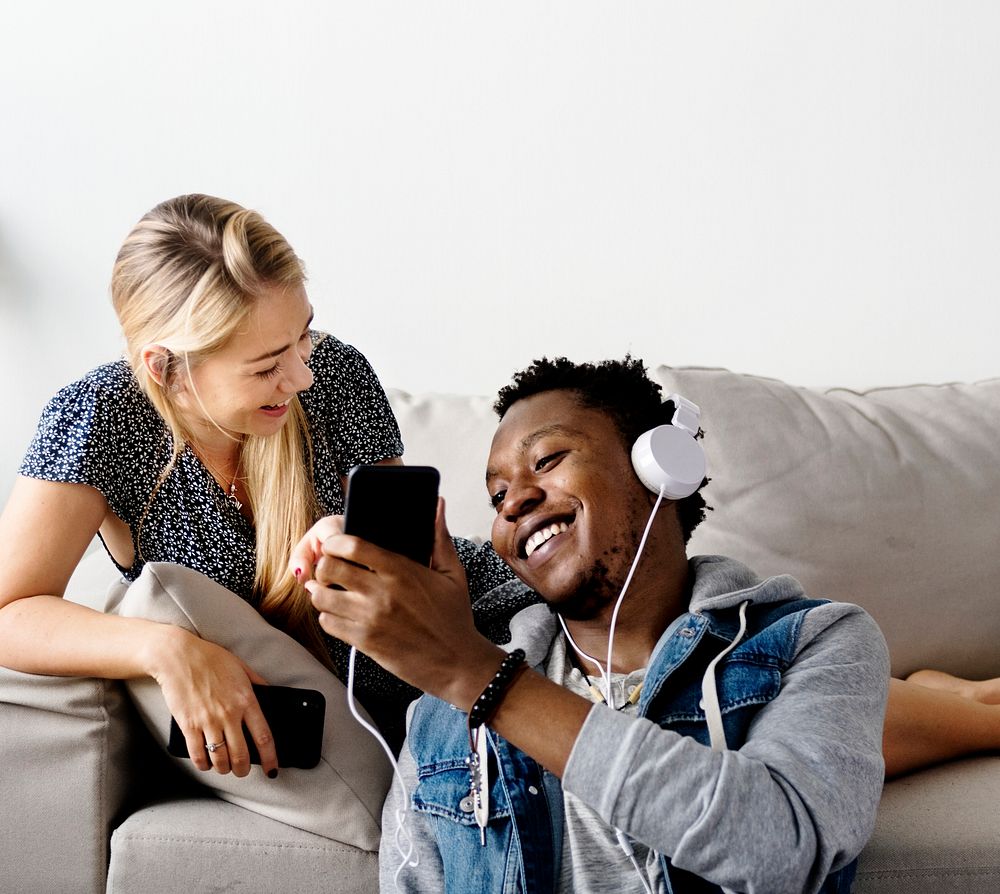 Couple listening to music on a couch