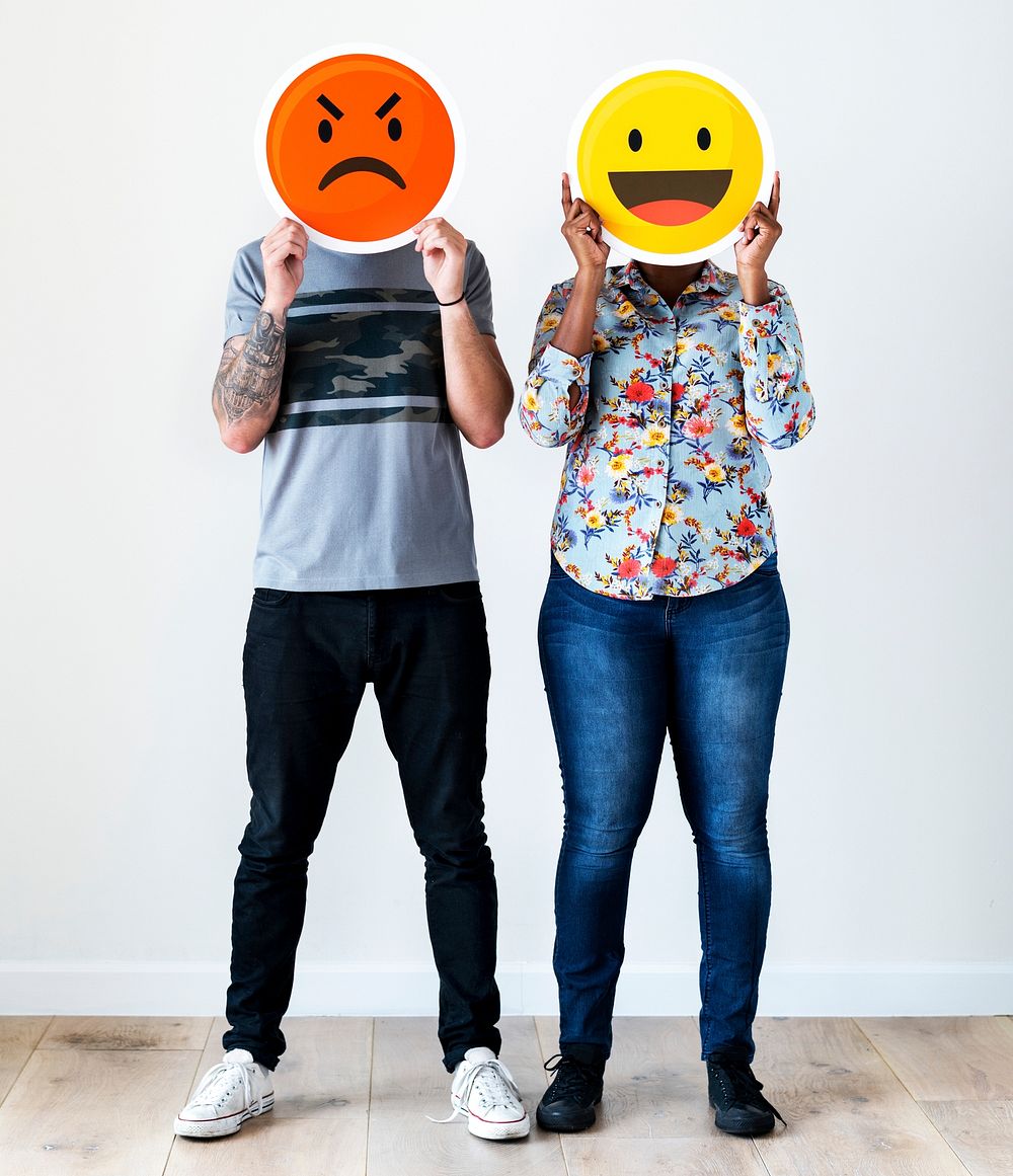 Couple holding an expressive emoticon face