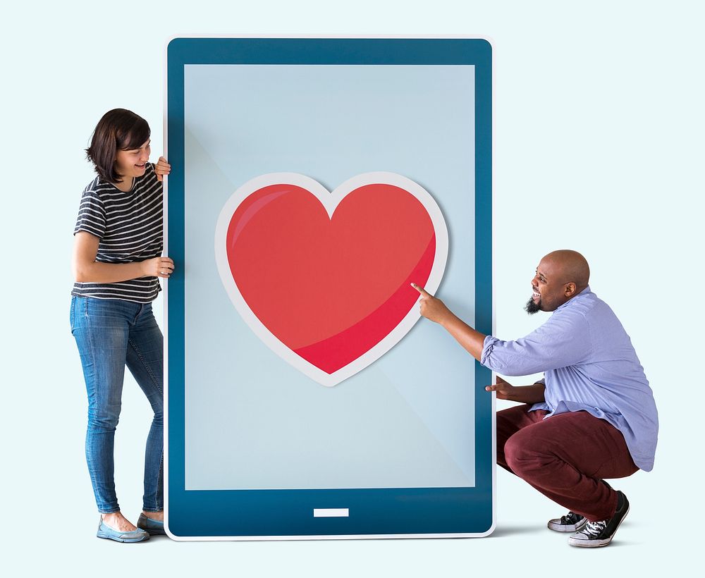 Diverse couple of people holding a tablet