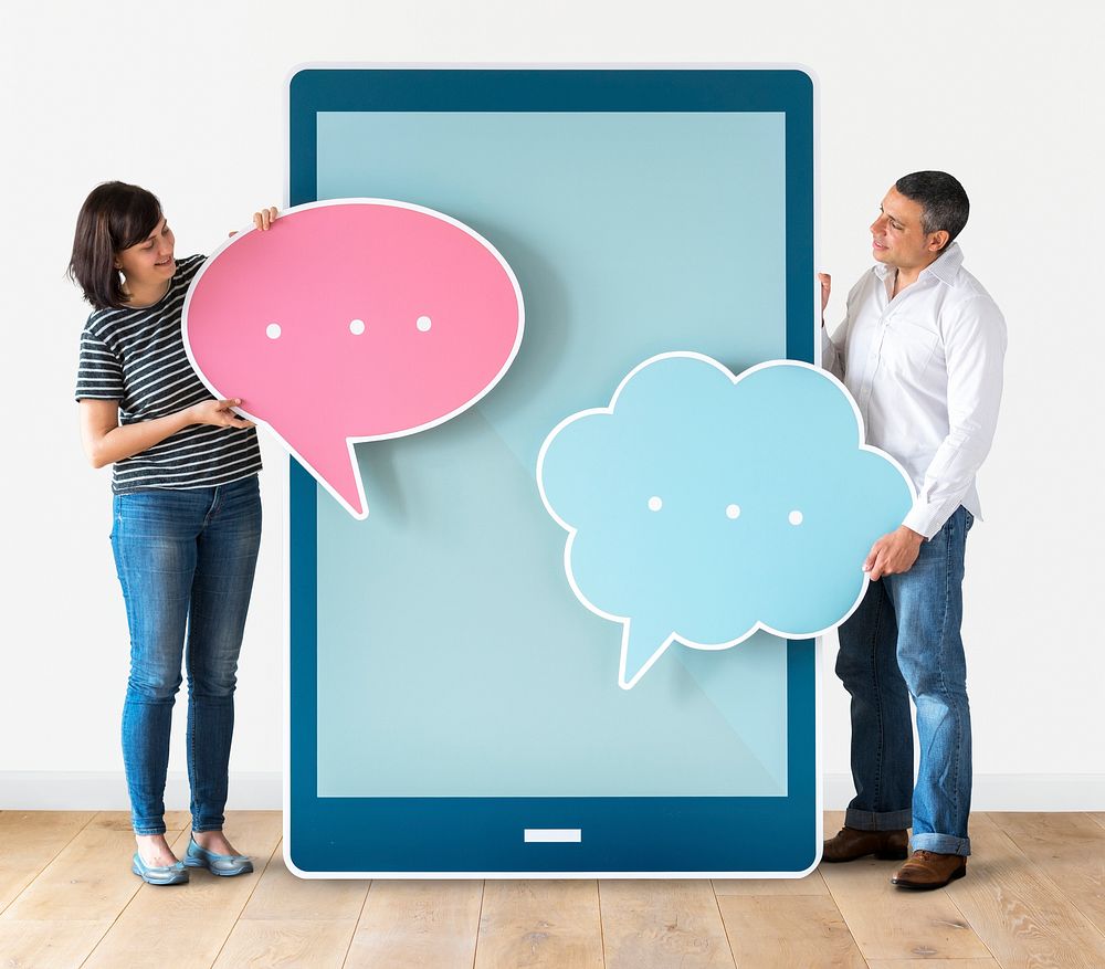 Diverse people holding speech bubbles and tablet