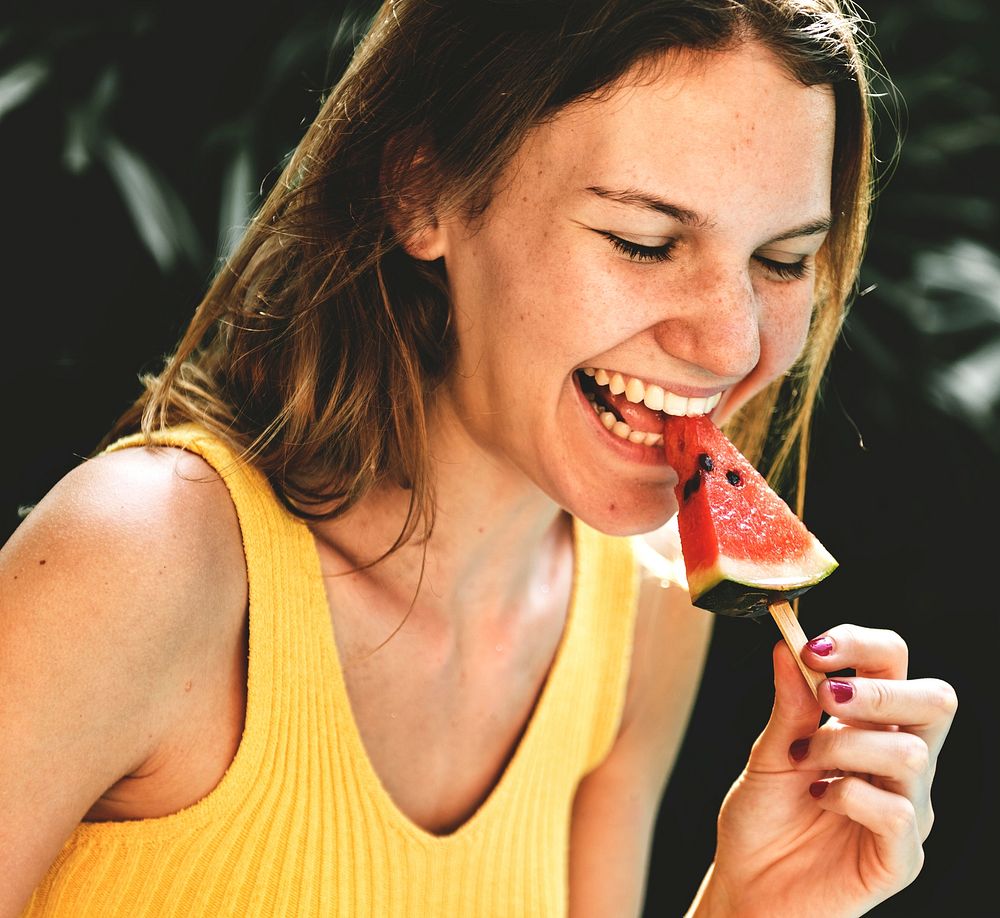 Caucasian woman eating watermelon in summertime