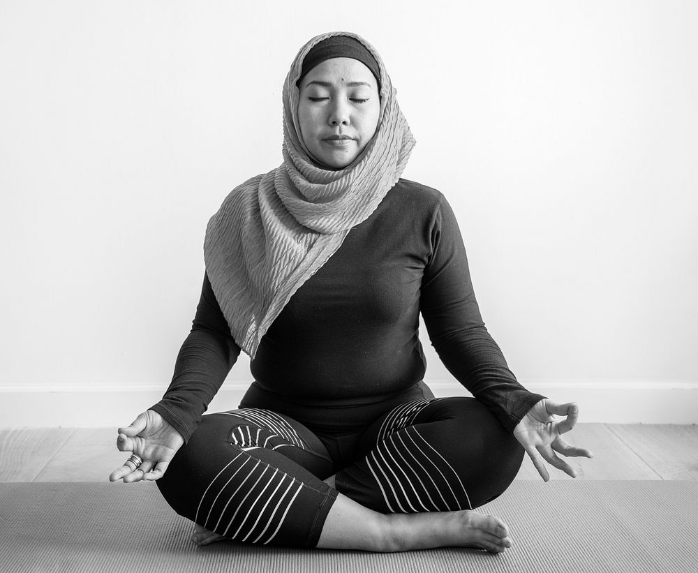 Islamic woman doing yoga in the room