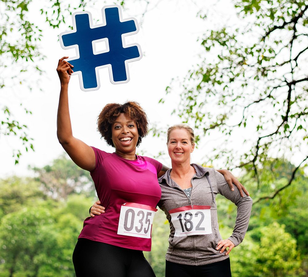 Diverse women with hashtag icon in the park