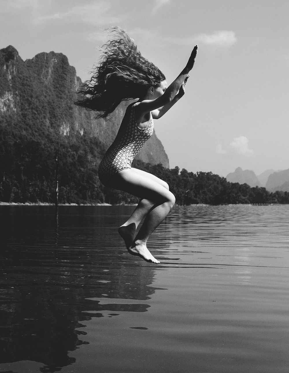 Woman jumping into the water