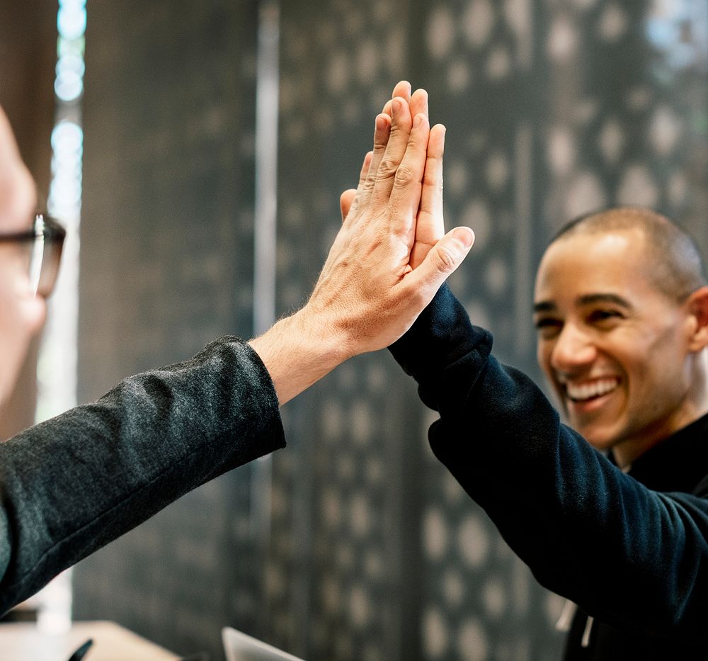 Colleagues giving a high five