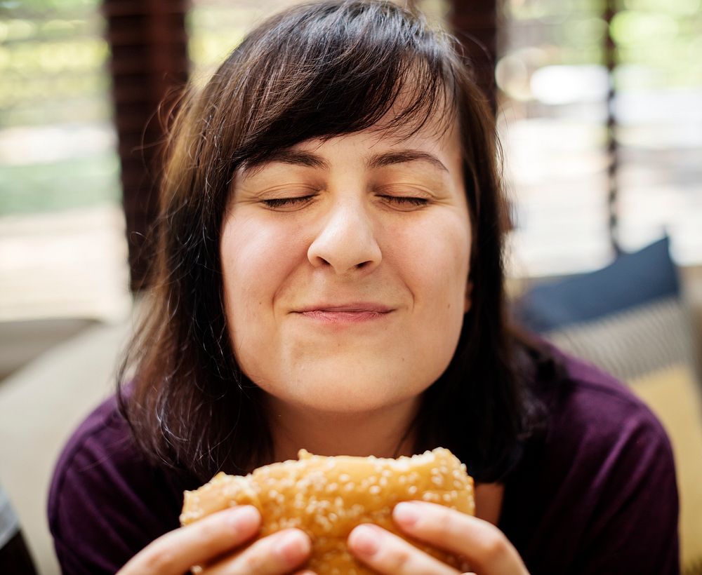 Happy woman with a big burger