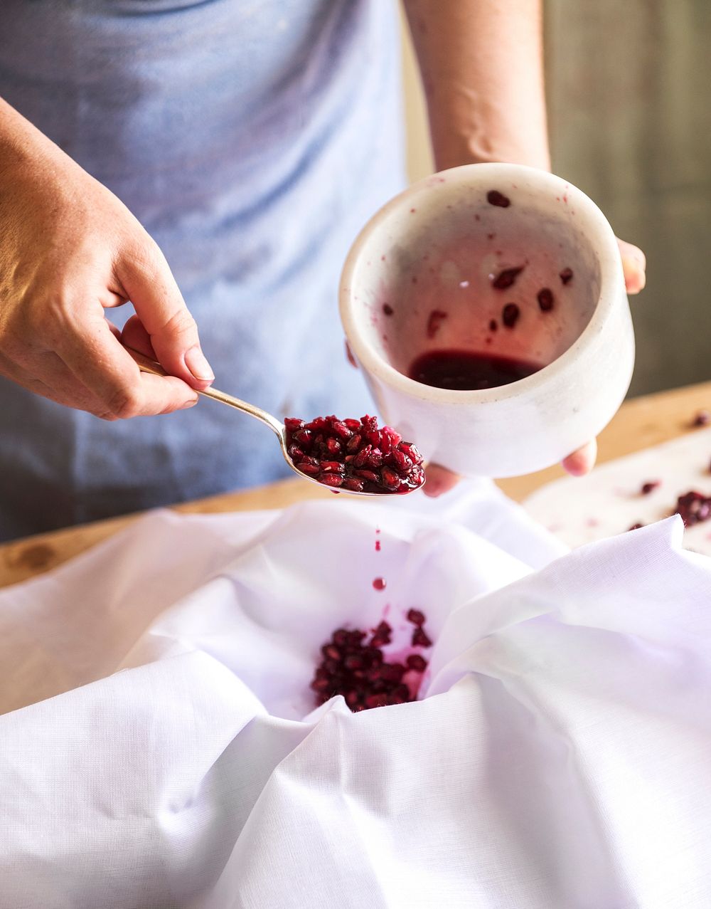 Baker separating juice from pomegranate seeds