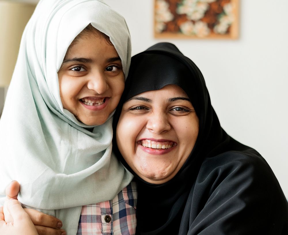Smiling portrait of a Muslim mother and a daughter