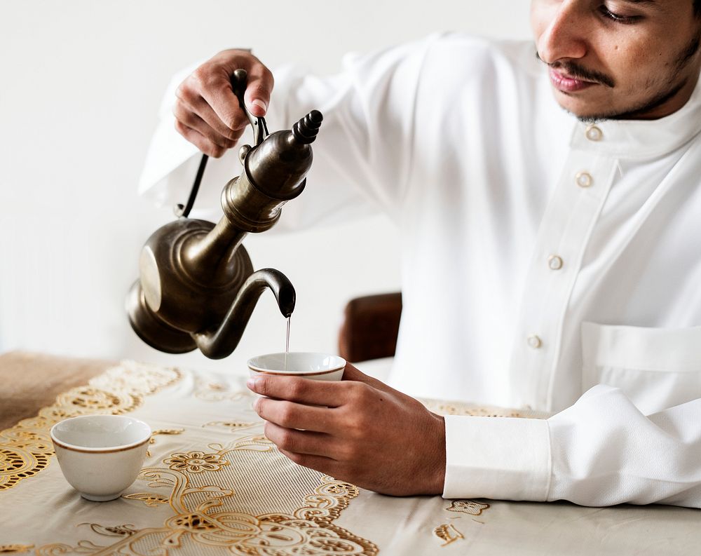 Muslim man having a cup of tea