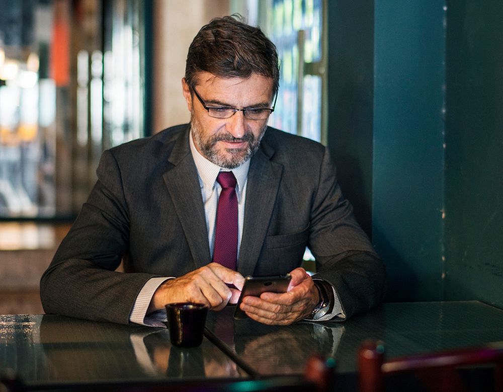 Businessman texting on his mobile phone