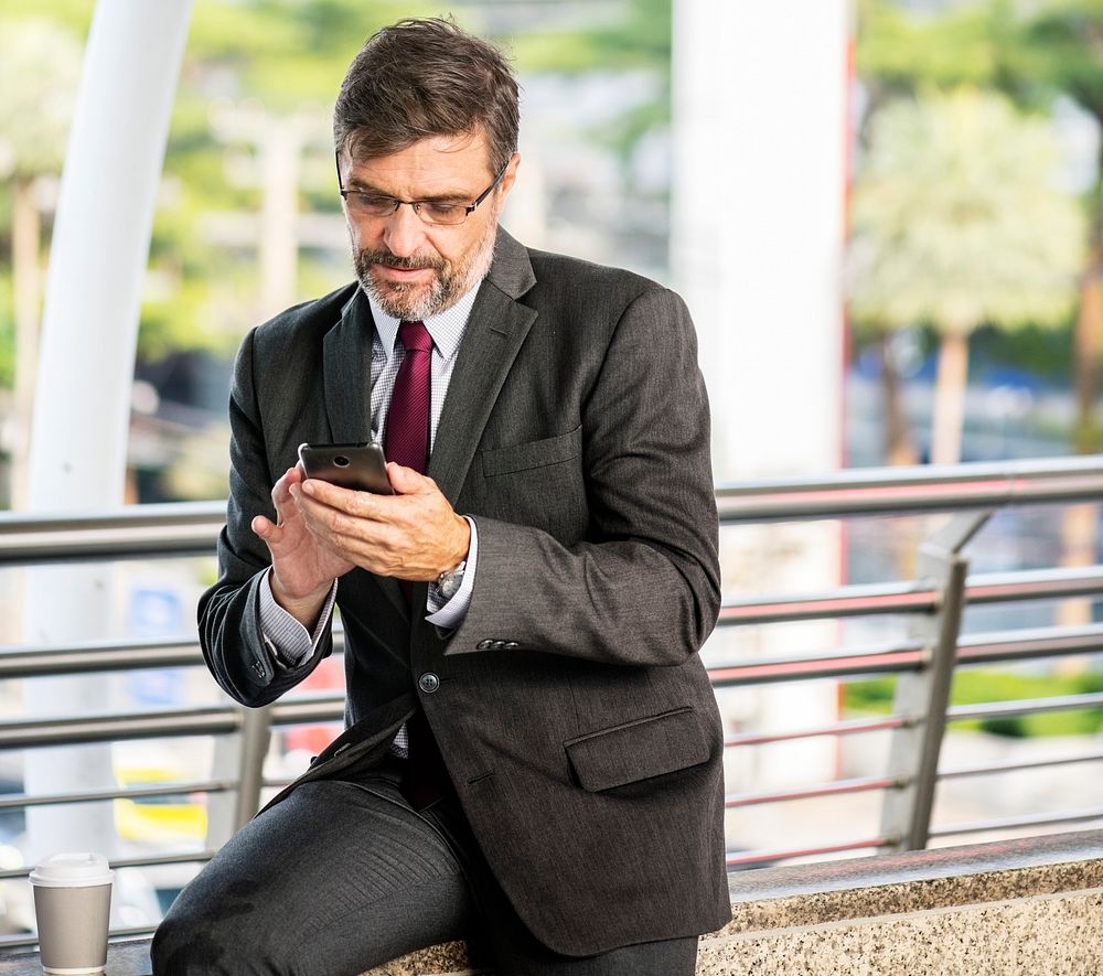 Busy businessman checking his phone