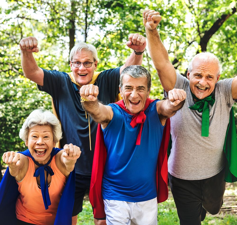 Childlike seniors wearing superhero costumes