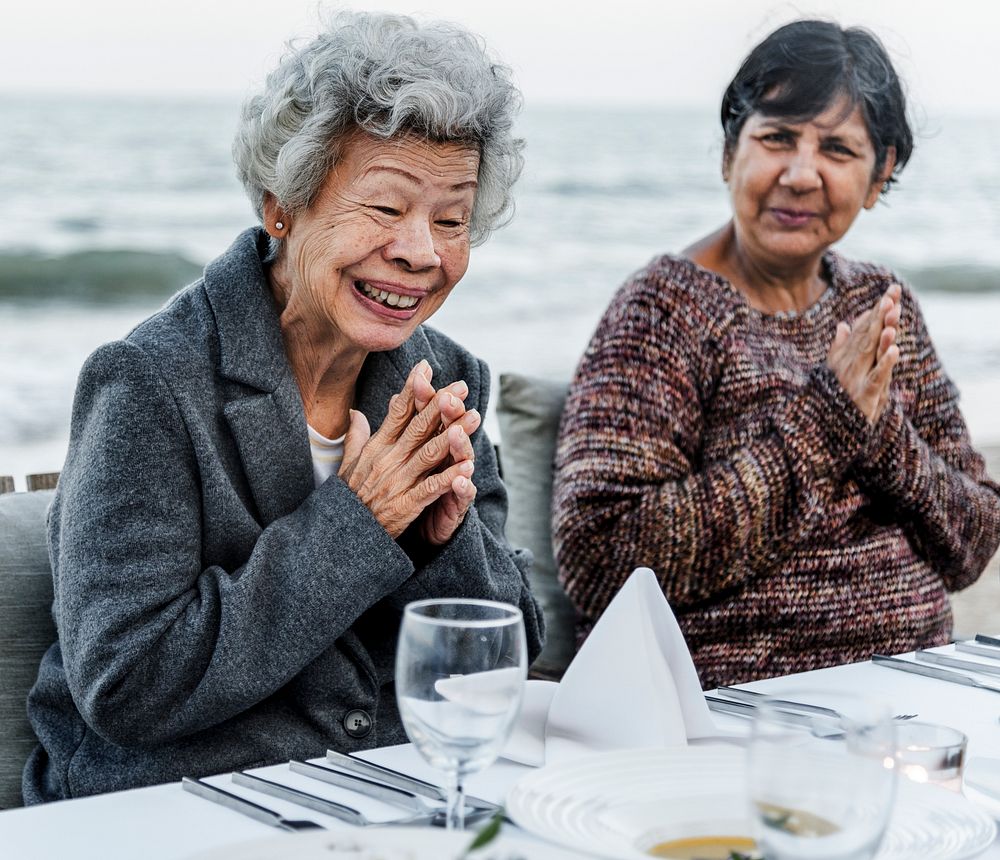 Seniors having a dinner party at the beach