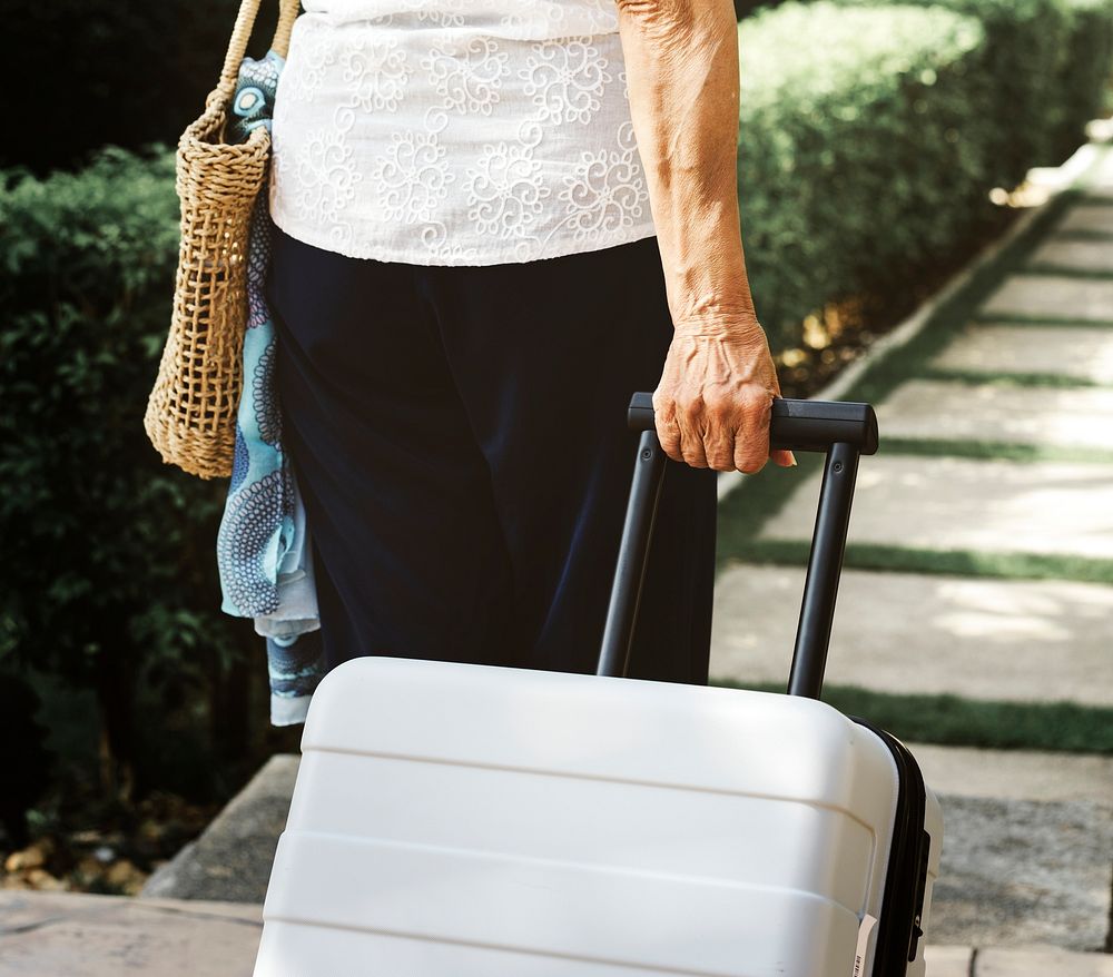 Senior woman pulling a suitcase