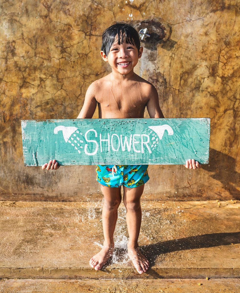 Boy holding a shower board sign