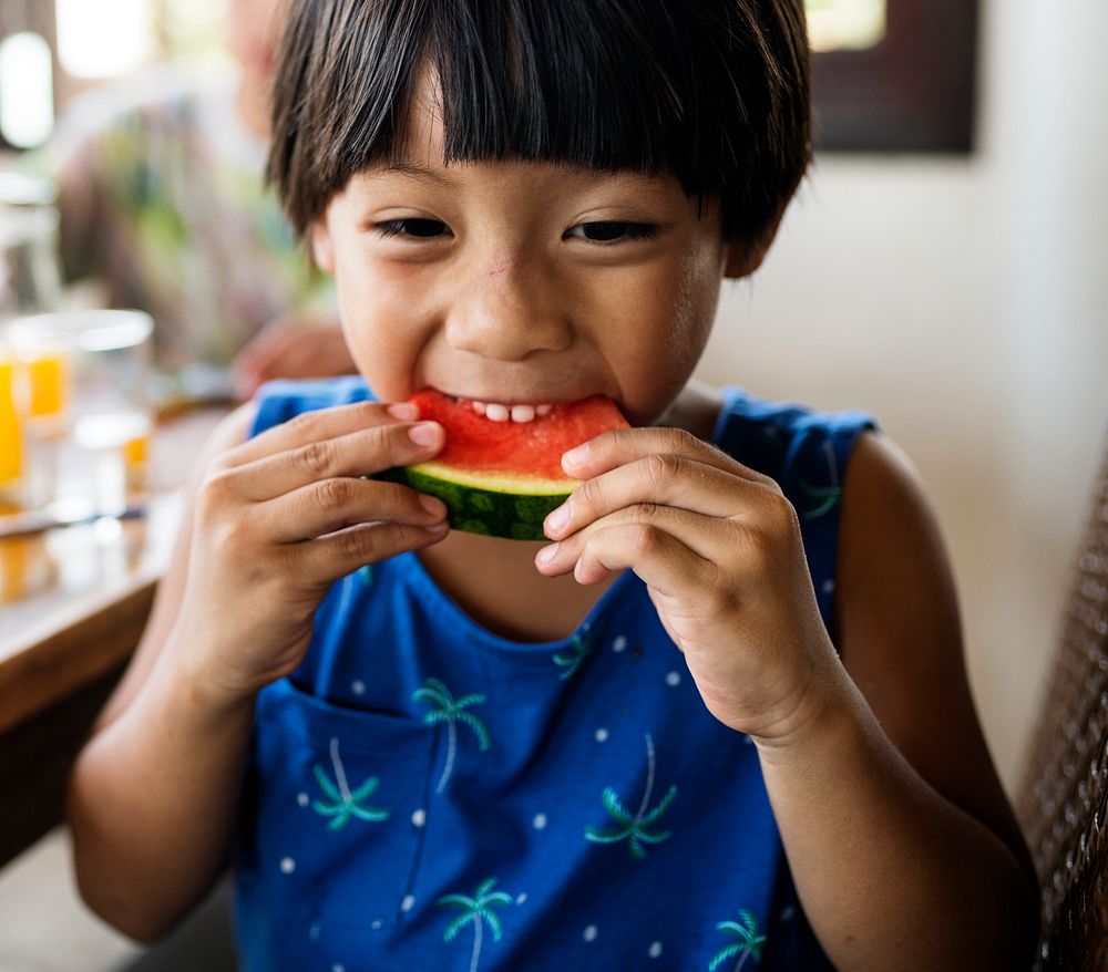 Little boy enjoying a piece of watermelon