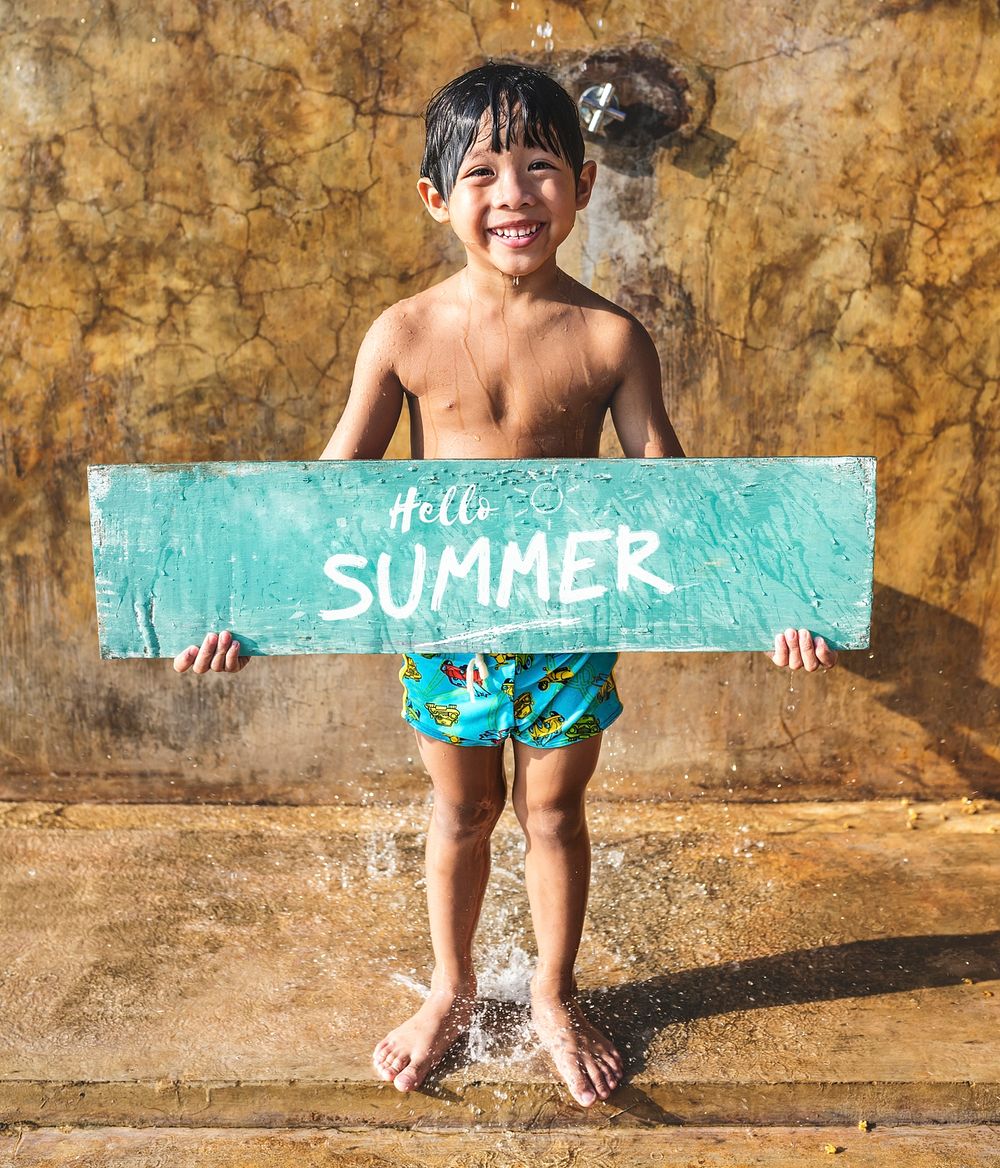 Boy holding a hello summer board