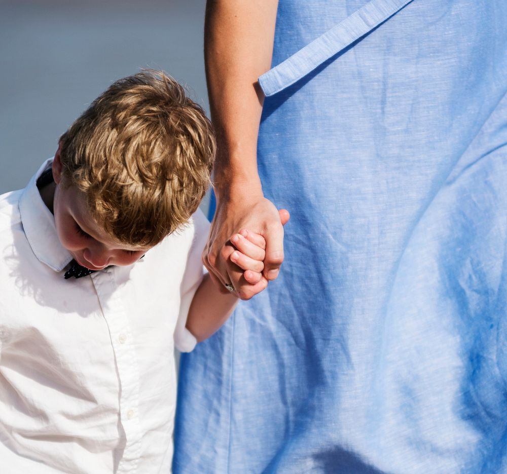 Mom and son walking at the beach