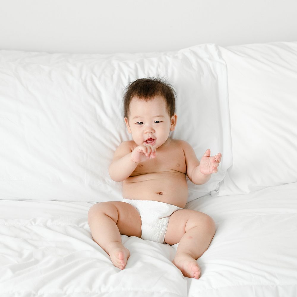 Cute Asian baby on a bed