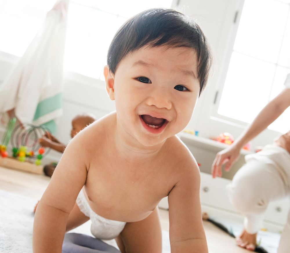 Asian baby crawling on the floor