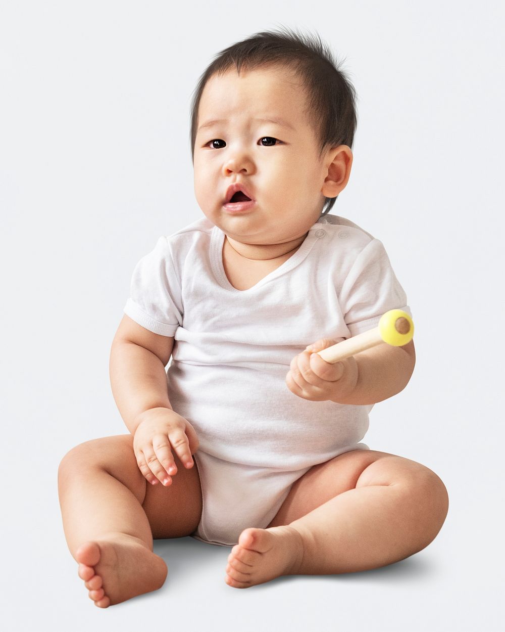 Confused Asian baby girl in a studio