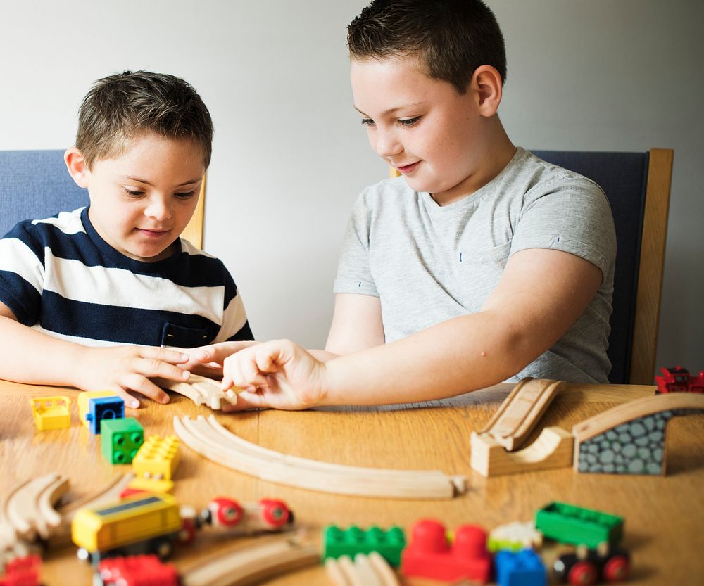 Brothers playing with blocks, trains and cars
