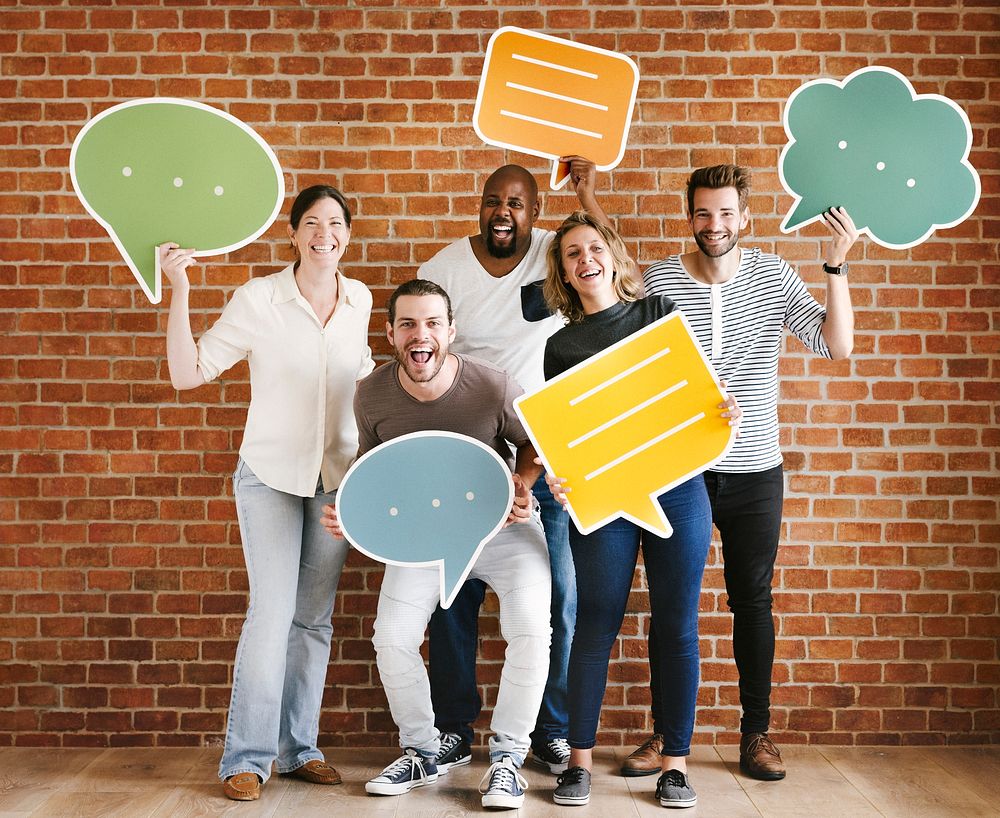 Diverse happy people holding speech bubble icons