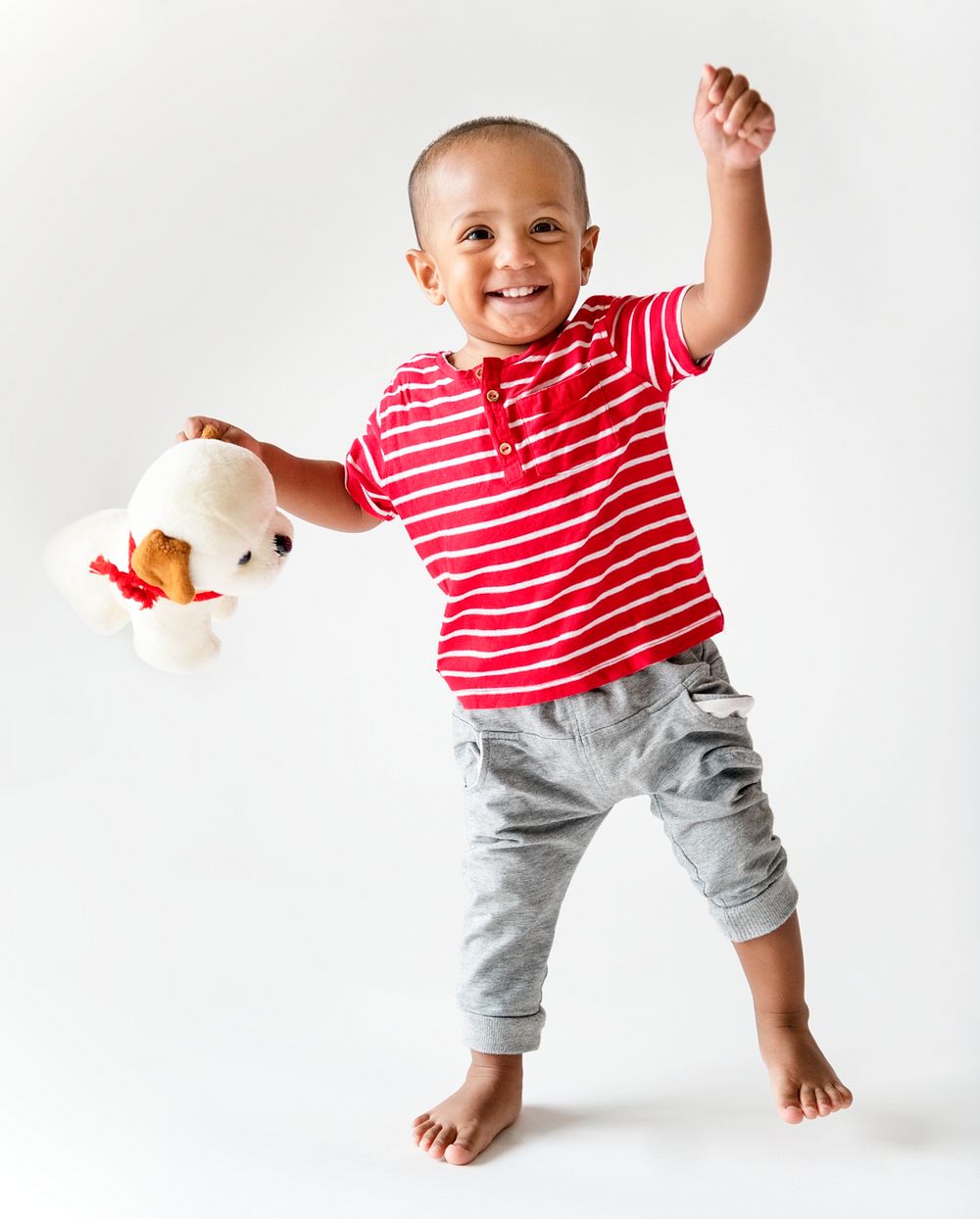 Cheerful young boy holding a soft toy