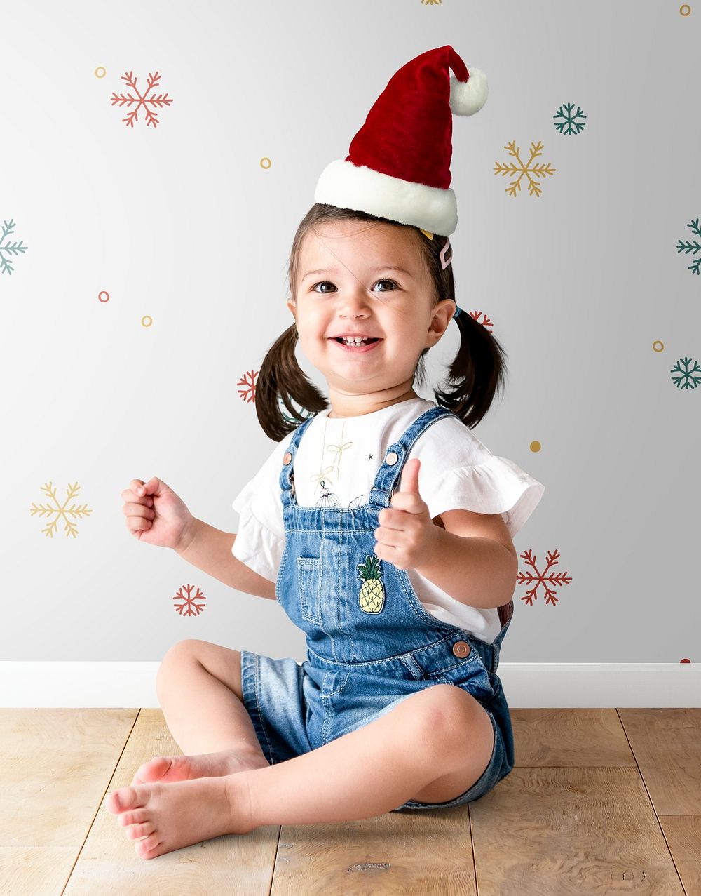 Cheerful little girl wearing a Christmas hat