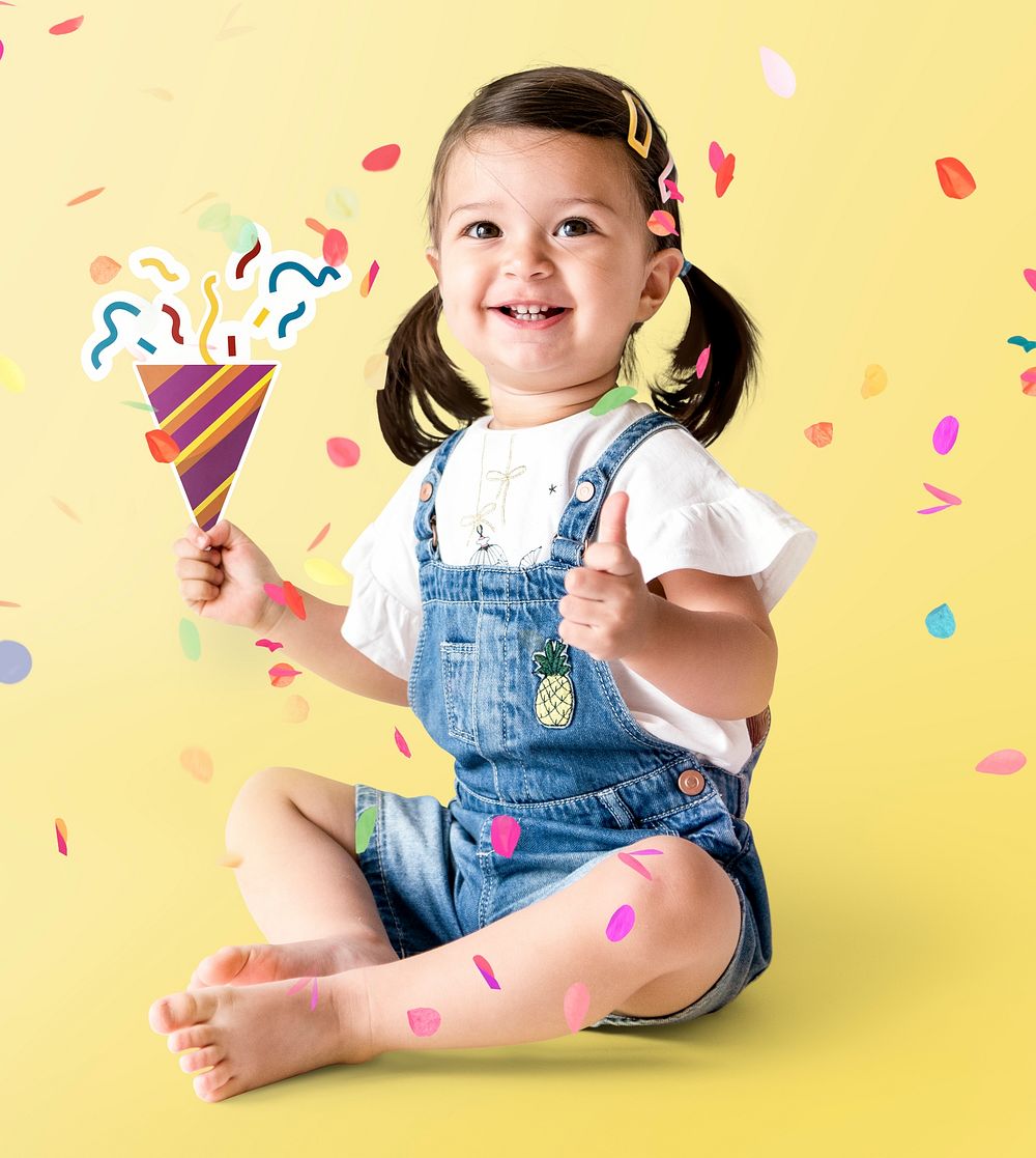 Cheerful little girl with party hat