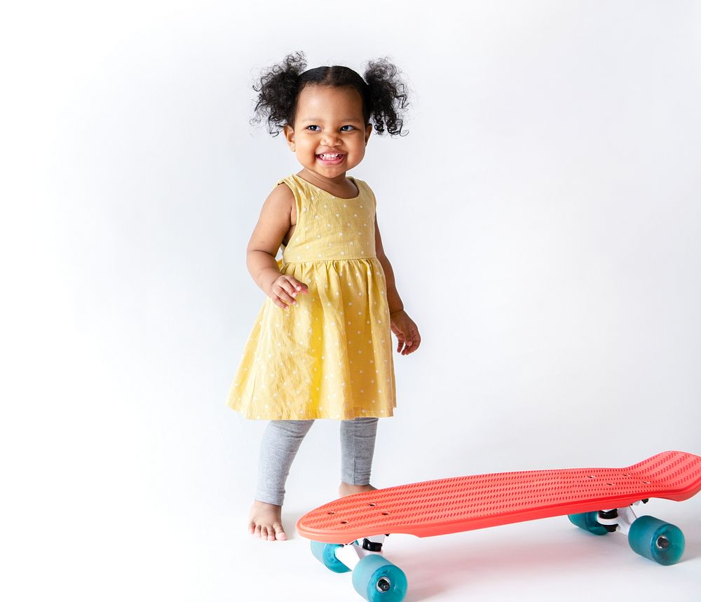 Happy little girl and a skateboard