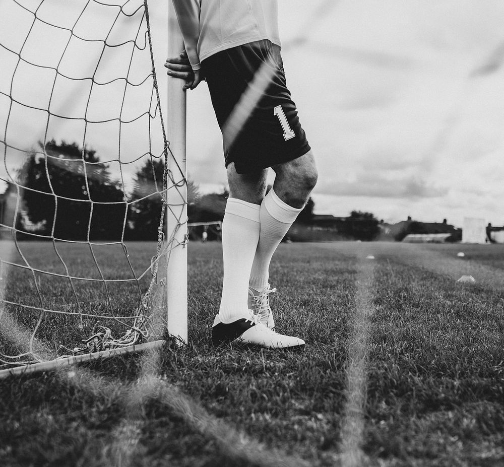 Male goalkeeper standing by the goal